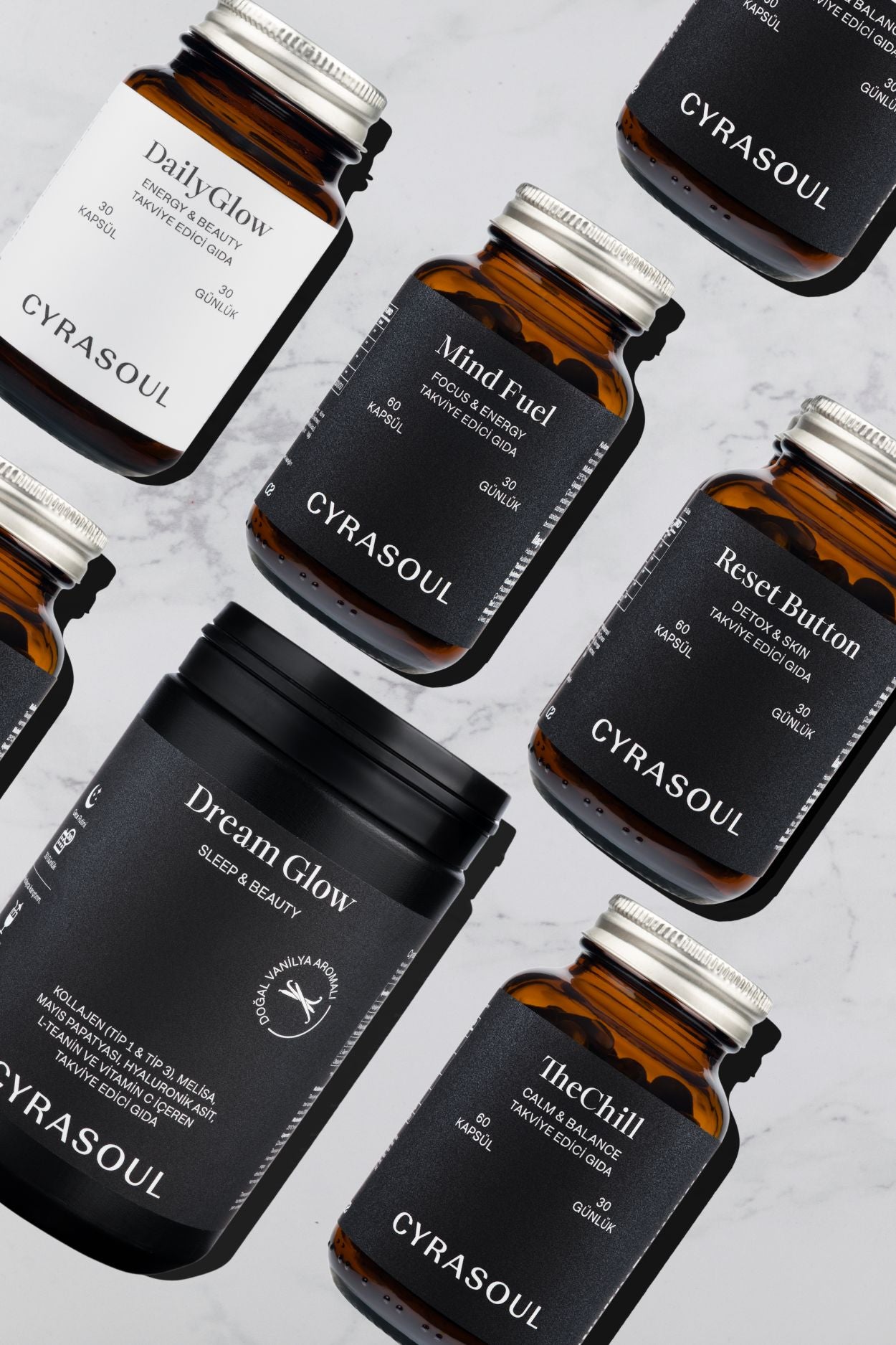 Cyrasoul’un lüks takviyeleri: DreamGlow, TheChill, DailyGlow, MindFuel ve ResetButton cam şişelerinde modern düzenleme